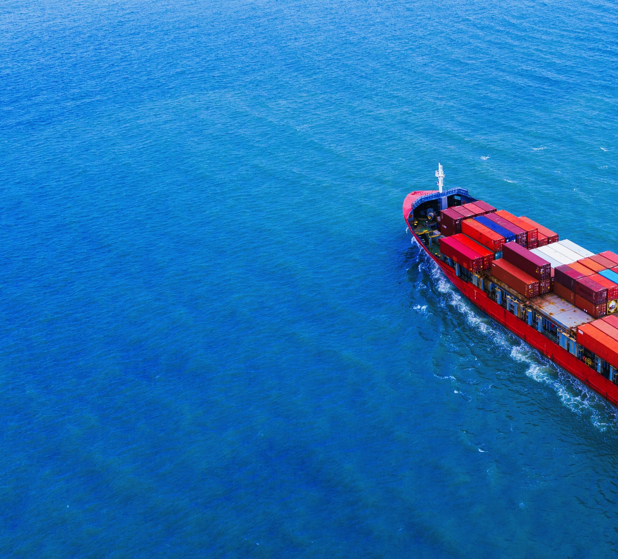 Aerial view of container cargo ship in sea.